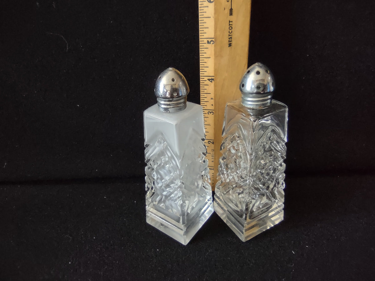 Top view of vintage pressed glass salt shaker with silver dome lid showing dispensing holes