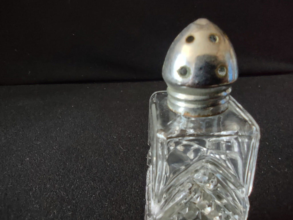 Close-up of pressed glass shaker base showing diamond crosshatch cut pattern