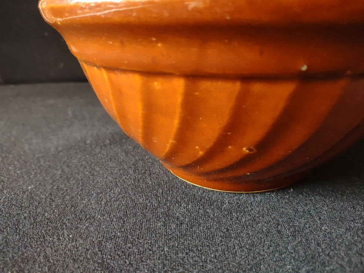 Vintage Hull Pottery mixing bowl bottom showing chip on foot ring