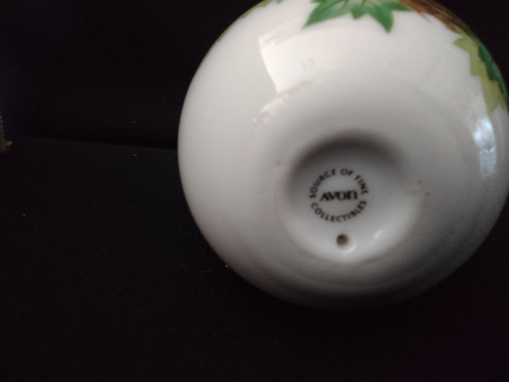 Avon Collectibles porcelain egg off-white body with floral decoration side view