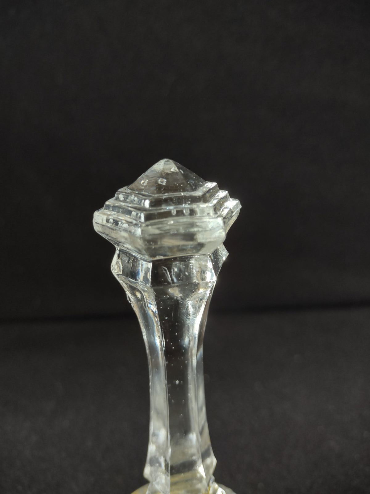 Close-up of cut crystal base with hand-painted yellow songbird and green foliage enamel decoration