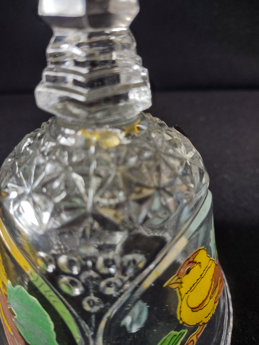 Detail of crystal cut pattern and hand-painted bird motif