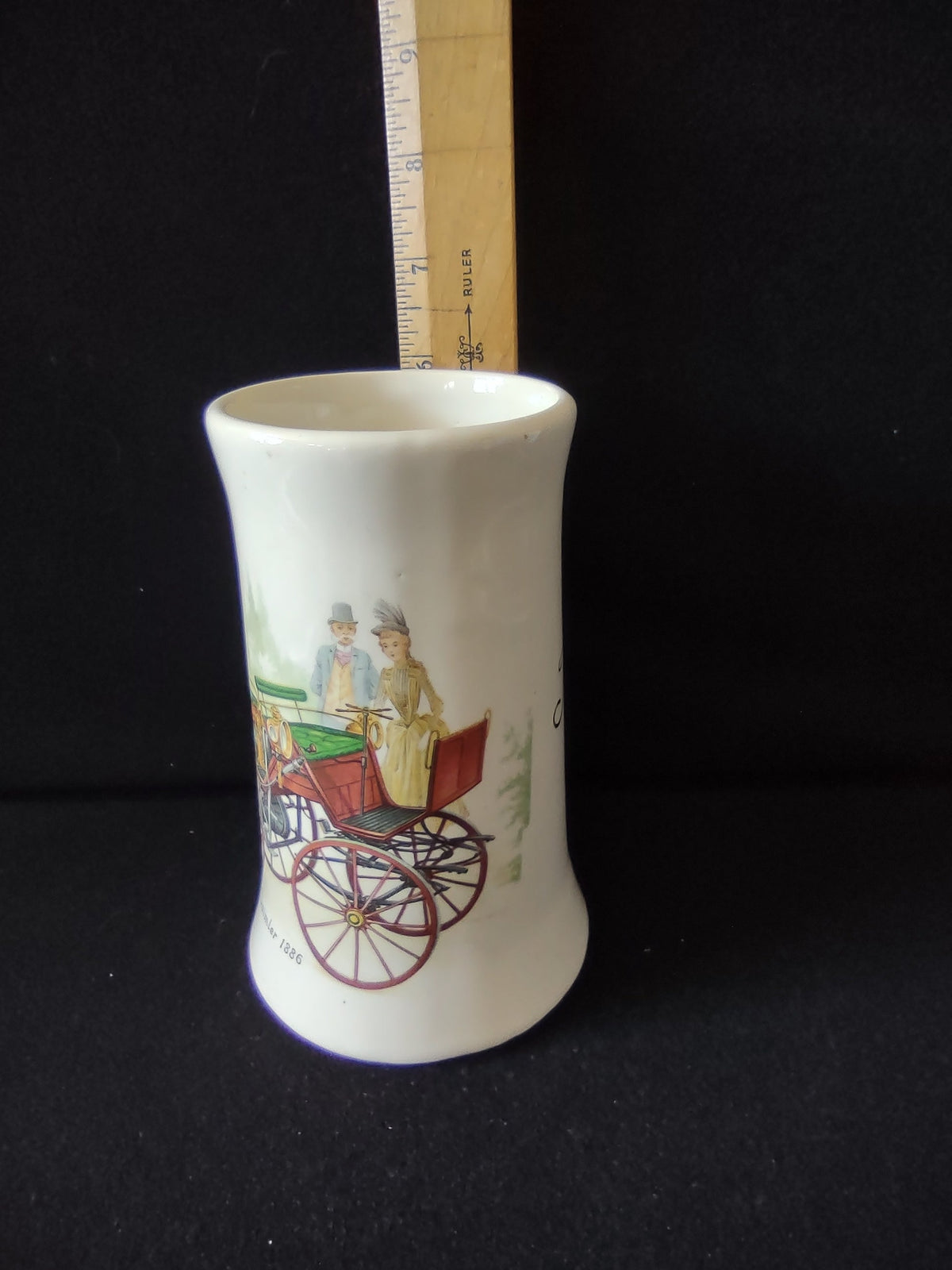 Side view showing script 'Tish' personalization with decorative flourish on off-white ceramic stein