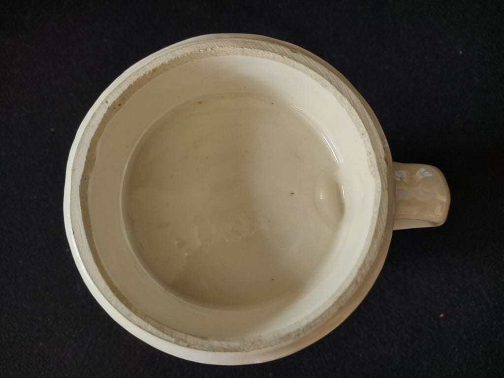 Three-quarter view of ceramic stein showing Daimler 1886 transfer print and handle