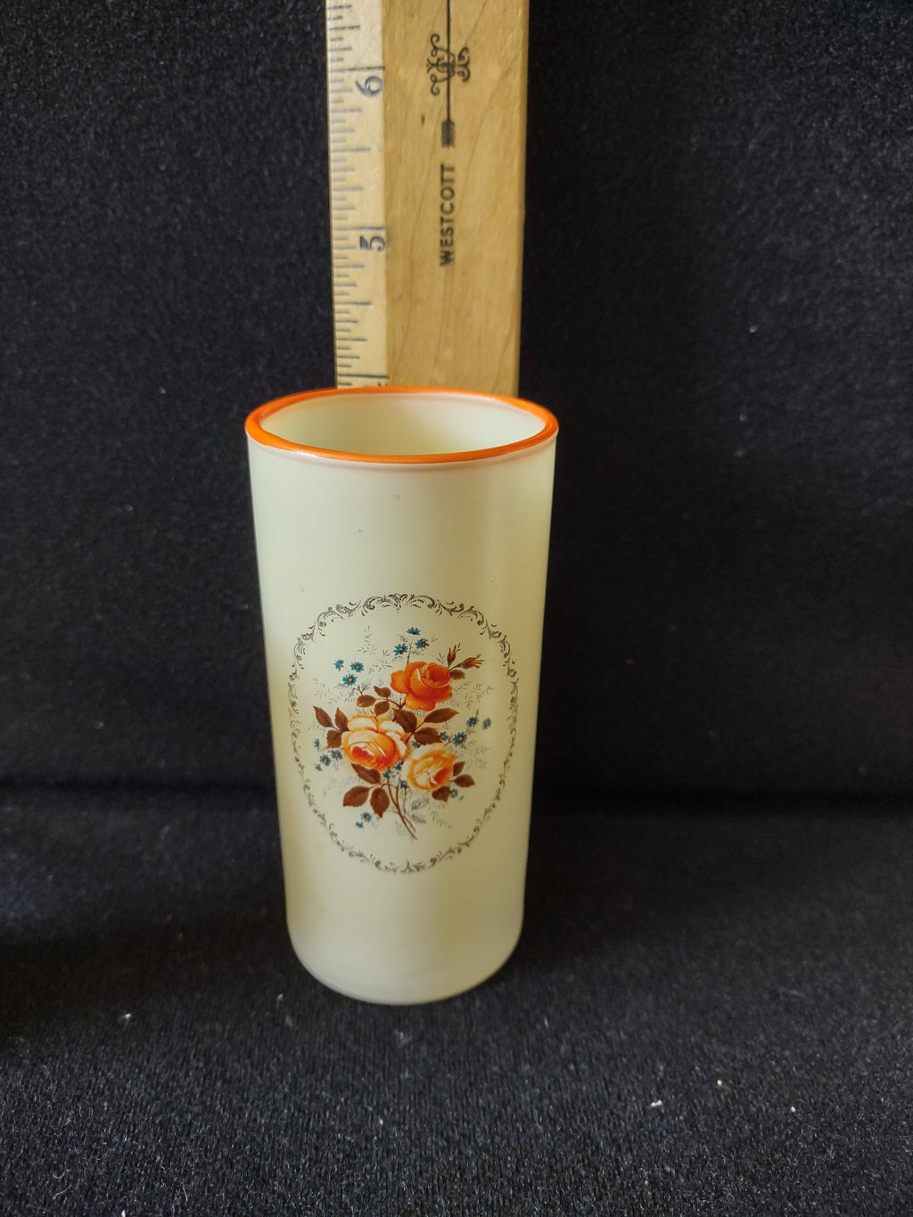 Close-up of orange rose medallion with gold scroll cartouche and teal forget-me-nots