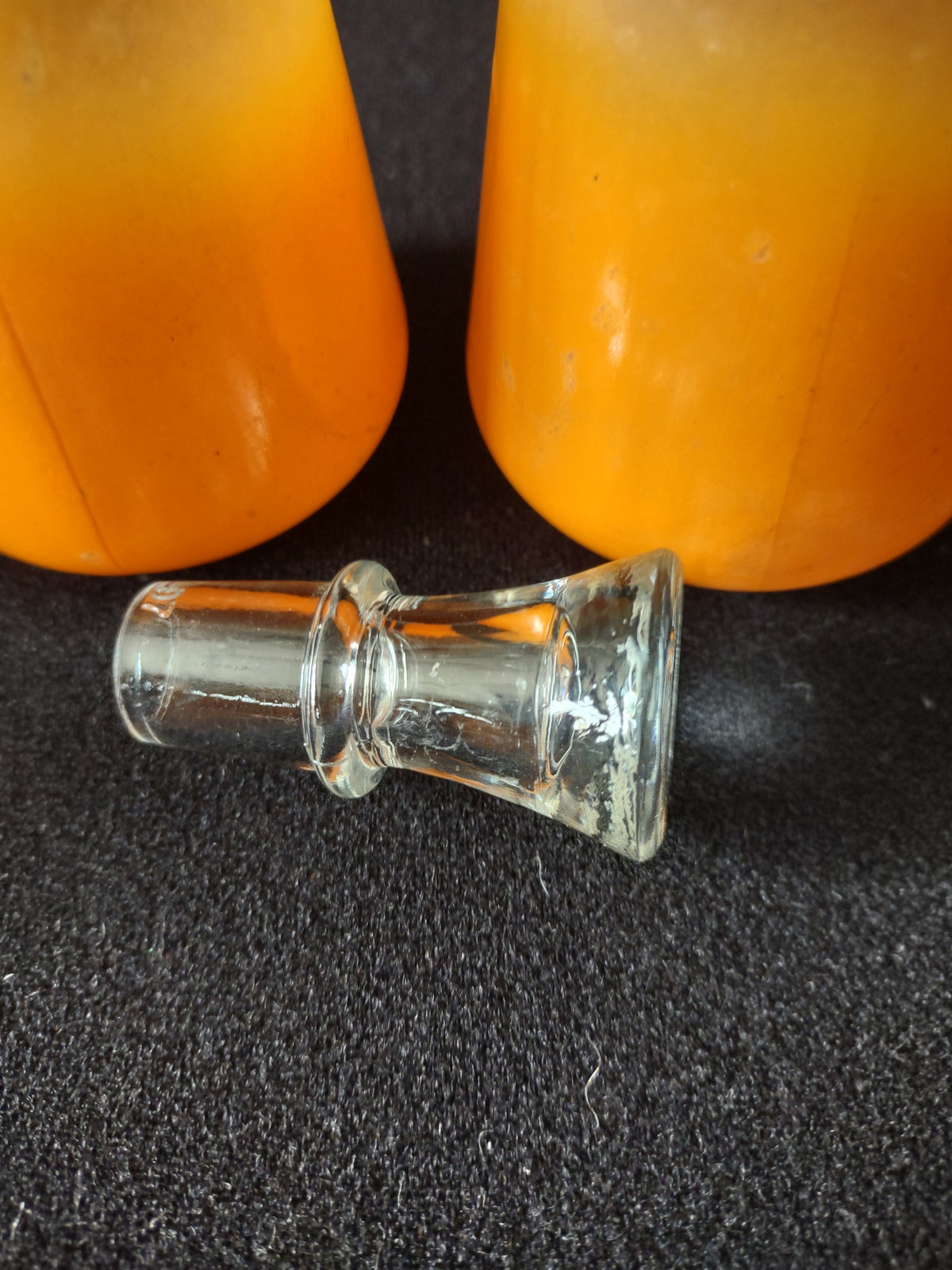 Close-up of silver dome lids on salt and pepper shakers showing tarnish