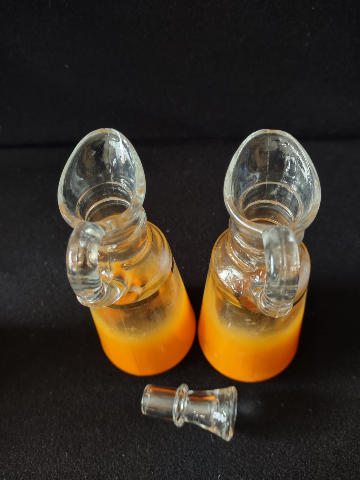Side view of orange gradient frosted glass with gold band trim