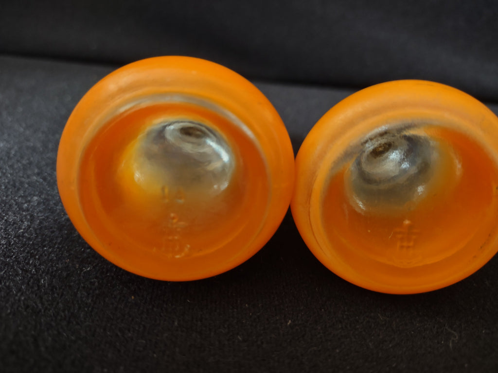 Bottom bases of shakers showing orange frosted glass construction