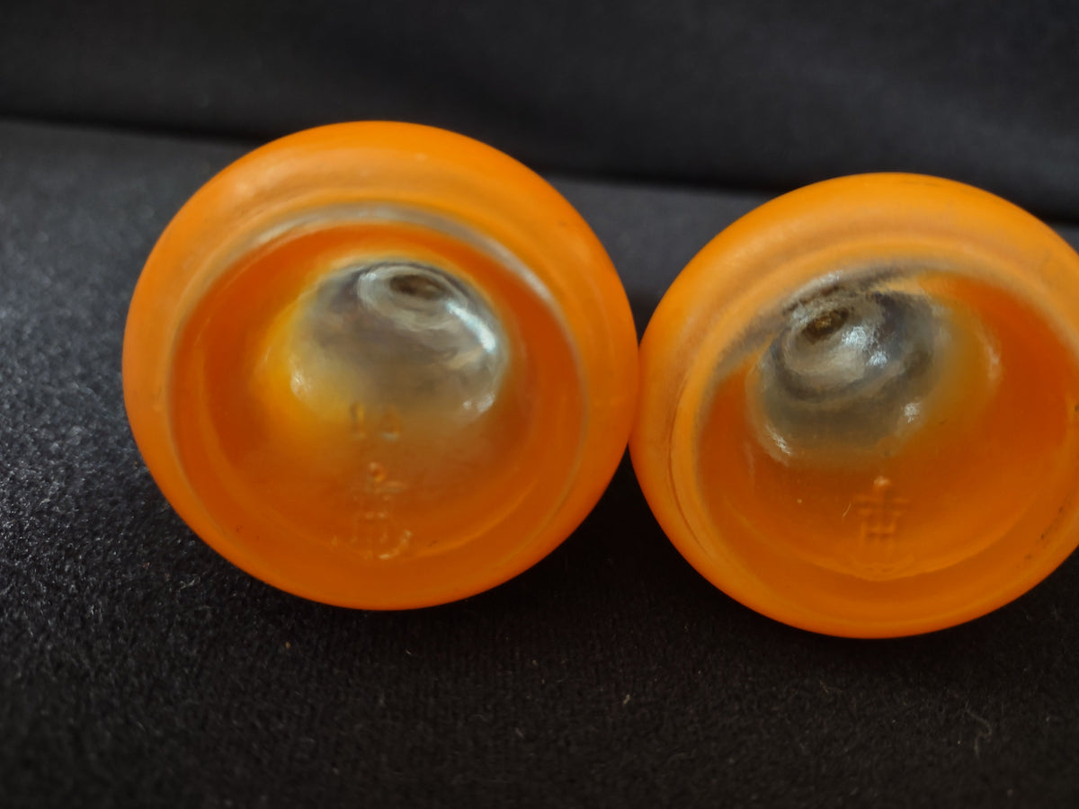Bottom bases of shakers showing orange frosted glass construction