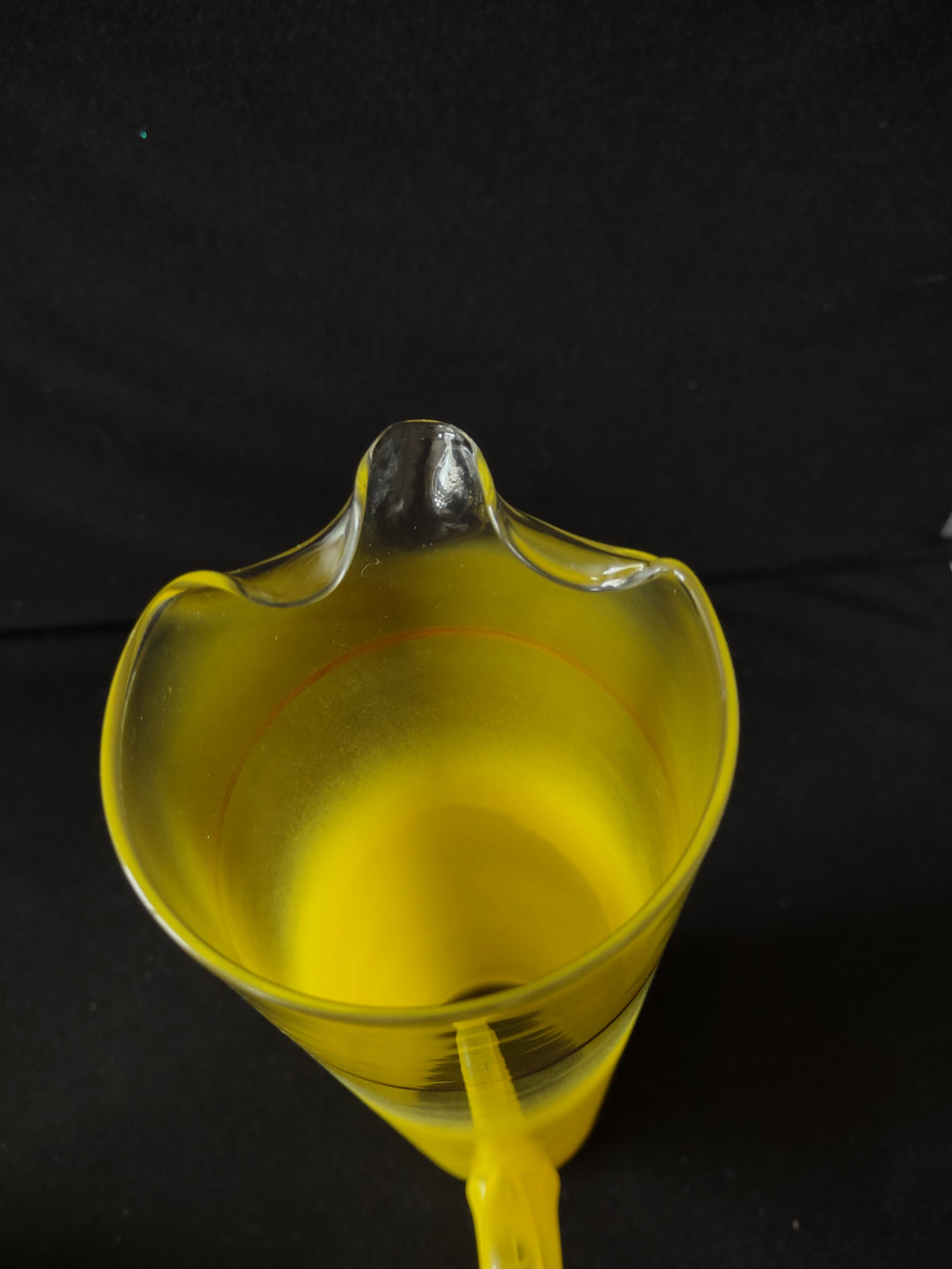 Vintage yellow frosted glass pitcher laying on side with ruler showing 12 inch length