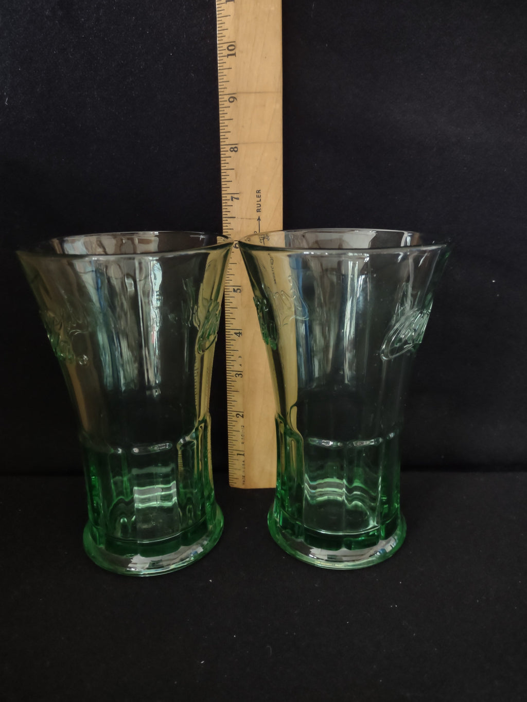 Vintage Coca-Cola green glass tumbler - close-up of embossed Coca-Cola script logo