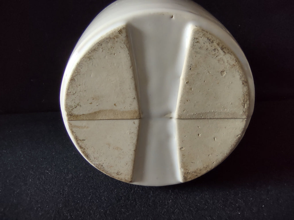 Side view of vintage stoneware pitcher without handle