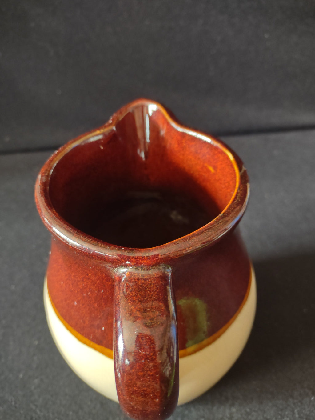Side view of vintage stoneware pitcher with ruler showing approximately 6 inch height