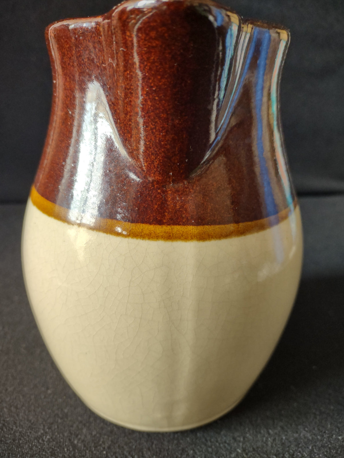 Top-down interior view of vintage stoneware pitcher showing brown glaze interior and bottom mark