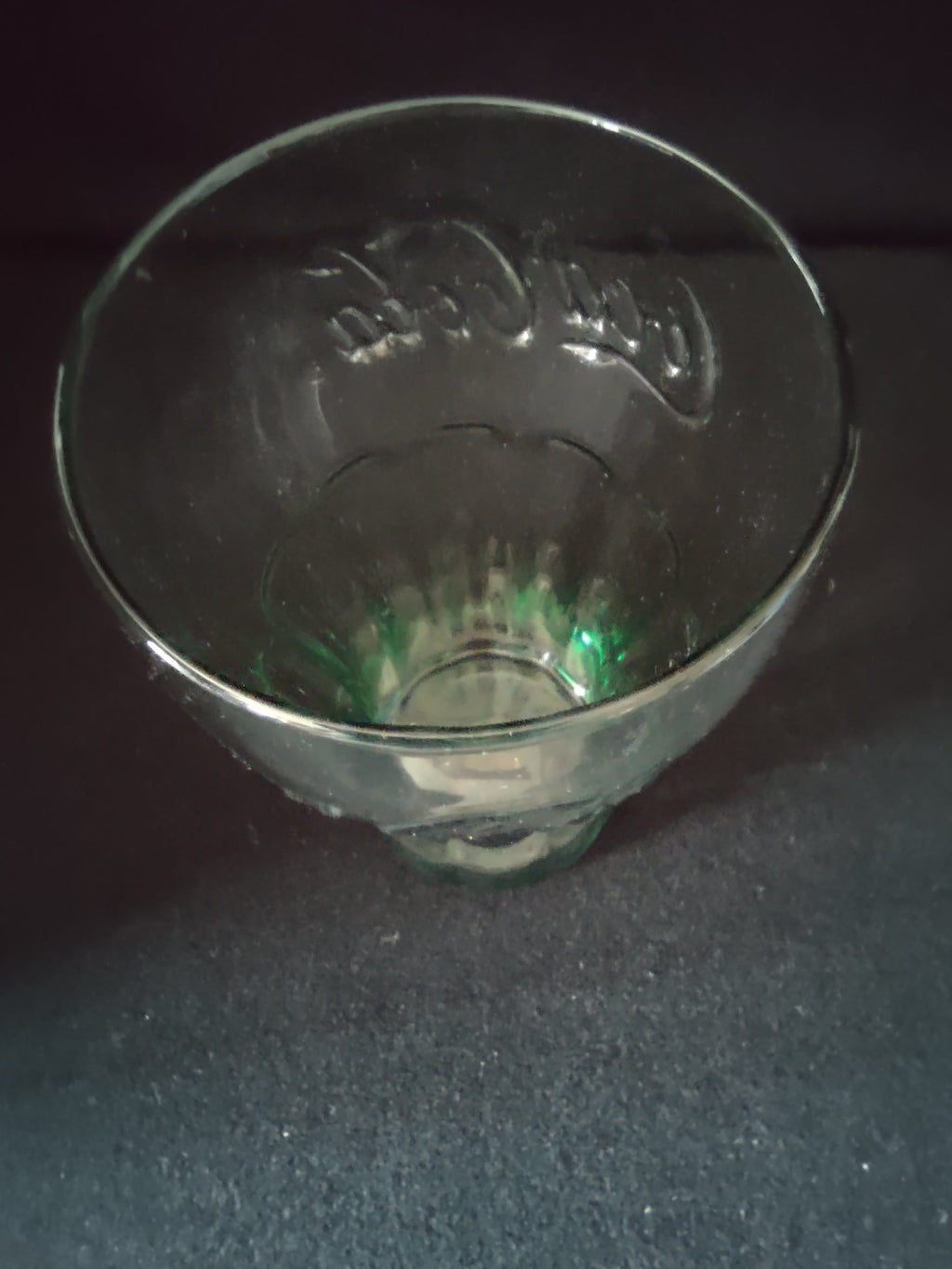 Top-down view of Coca-Cola green glass tumbler showing gold rim detail