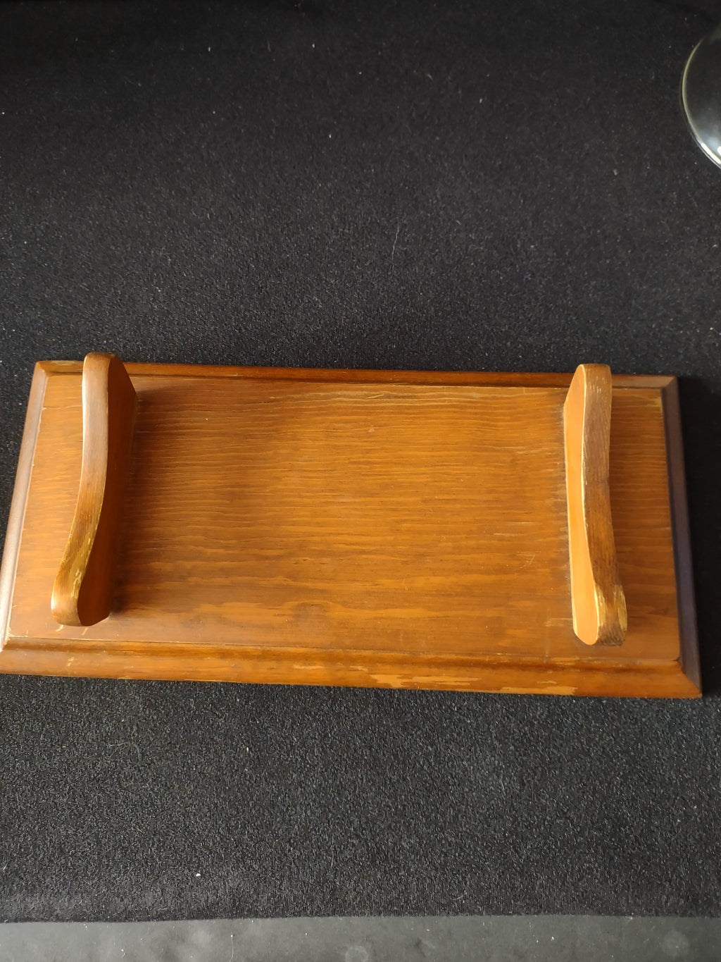 Side view of wood cradle stand showing curved saddle supports and rectangular base