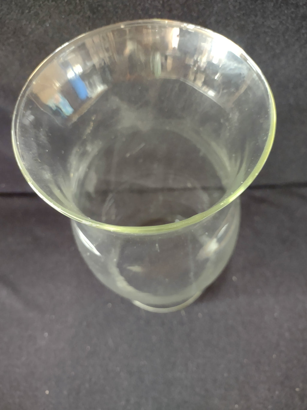 Bottom view of vintage clear glass hurricane shade showing circular base opening