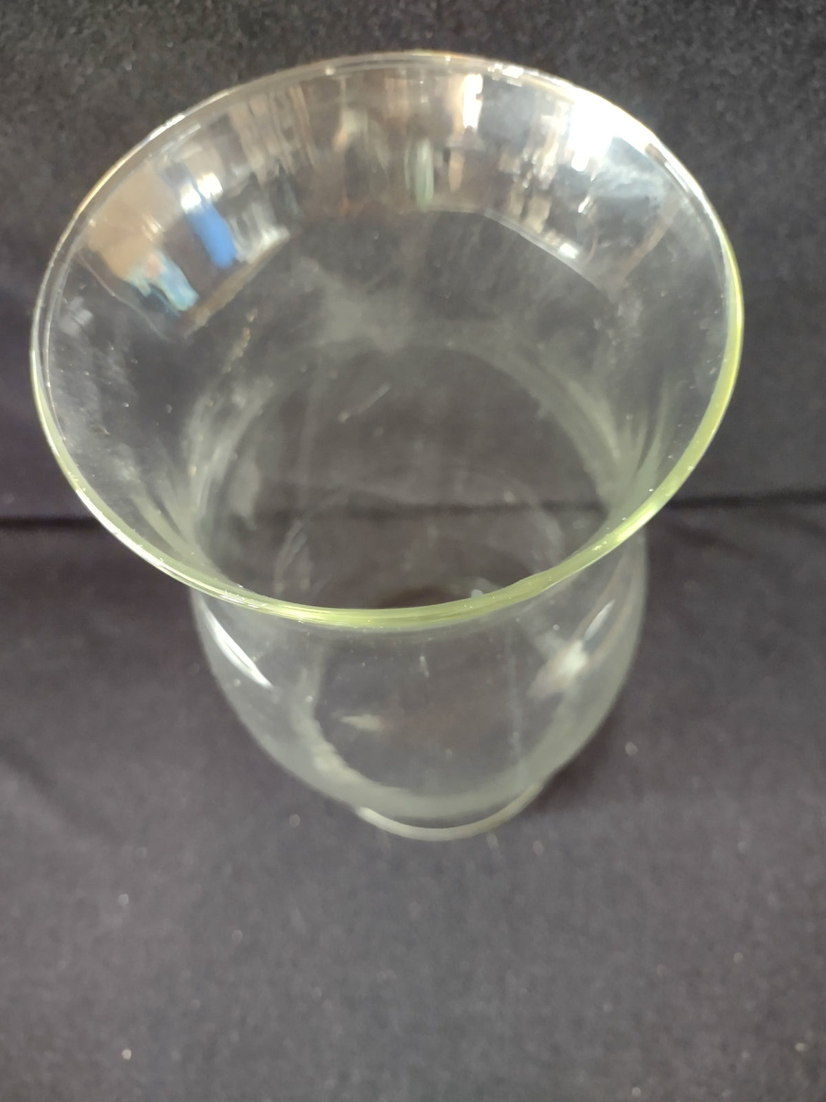 Bottom view of vintage clear glass hurricane shade showing circular base opening