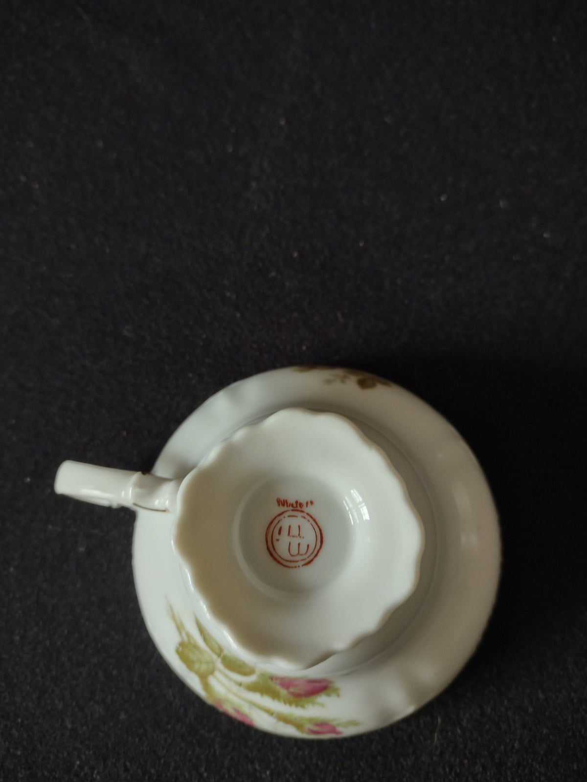 Saucer interior showing moss rose motif and gold rim