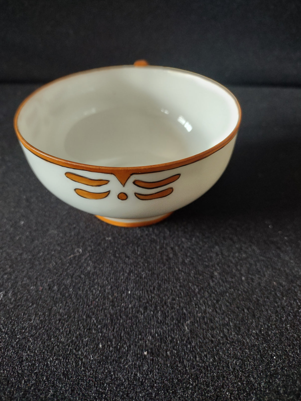 Side view of cup with Art Deco orange motif