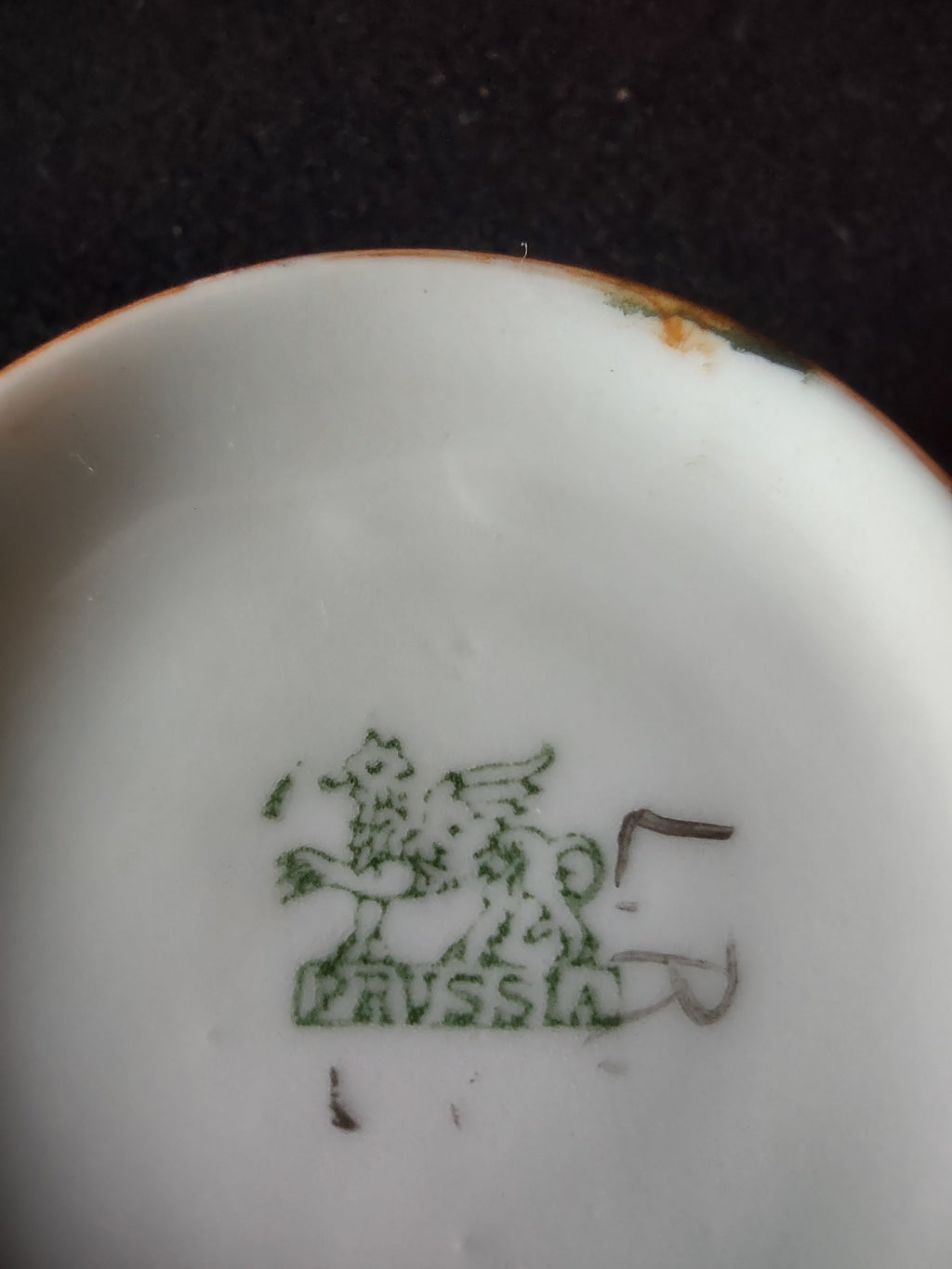 Vintage Japanese Art Deco cup and saucer set, orange wing motif, front view