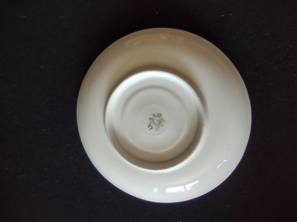 Close-up of orange Art Deco wing motif on cup