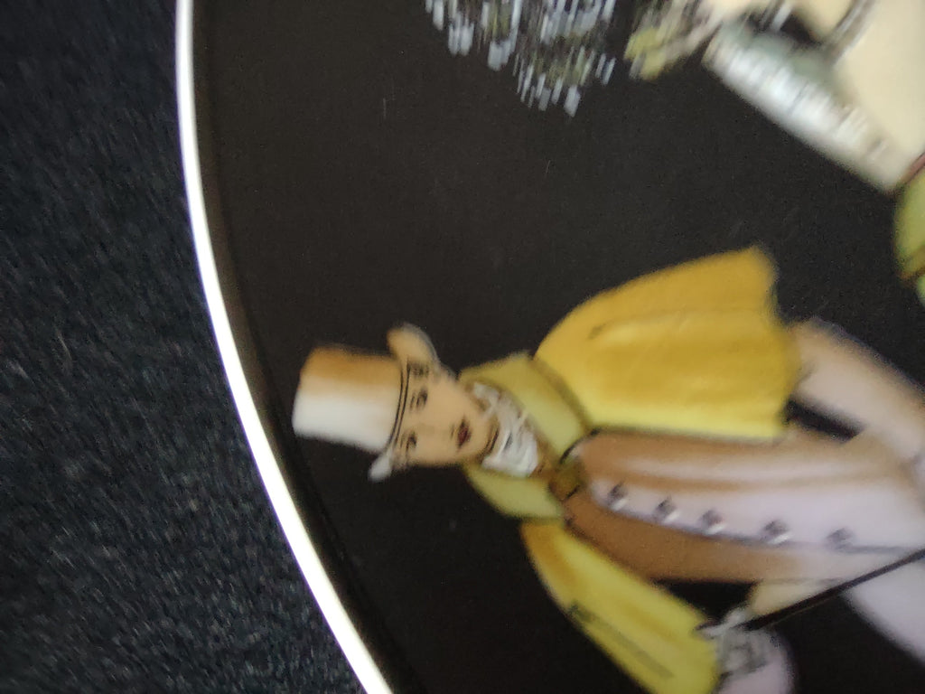 Close-up of gentleman in top hat, grey houndstooth coat with walking stick
