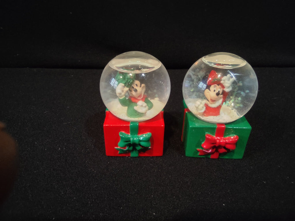 Mickey Mouse Christmas snow globe close-up, green outfit holding mistletoe, red gift box base