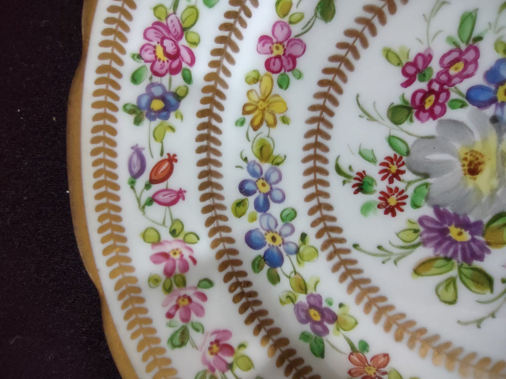 Hand painted mixed floral plate - rim close-up showing HAIRLINE CRACK near scalloped edge