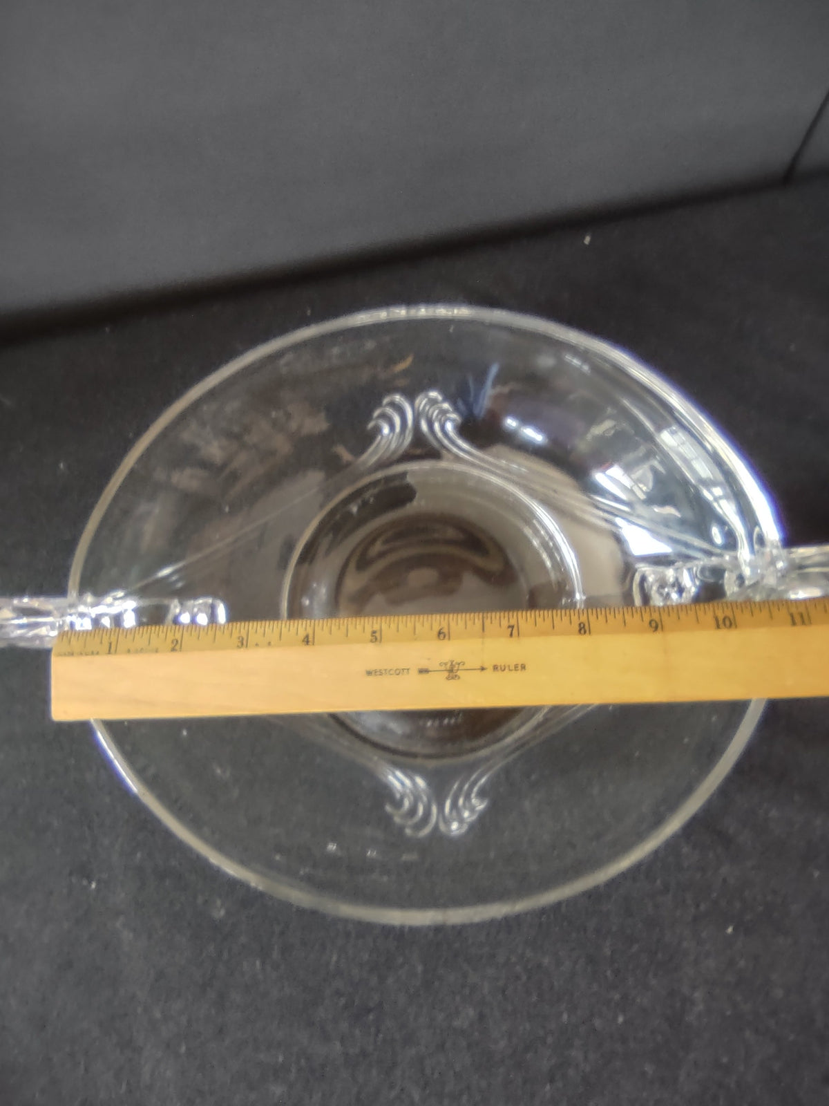 Close-up of swept feather-wing handle detail showing layered curved fin design