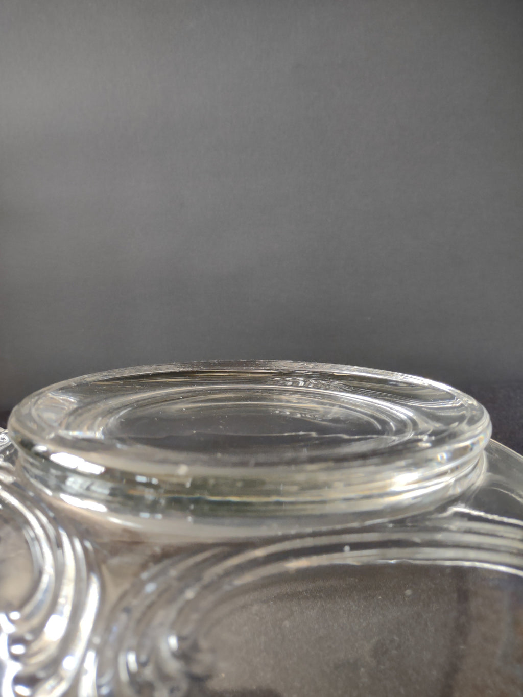 Side profile view of clear glass relish dish showing overall form and wing handle spread