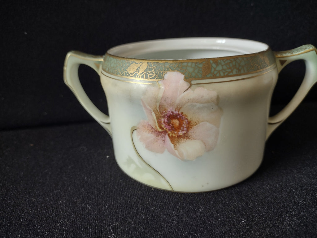 Sugar bowl side view showing blush pink open wild roses on pale cream-green ground