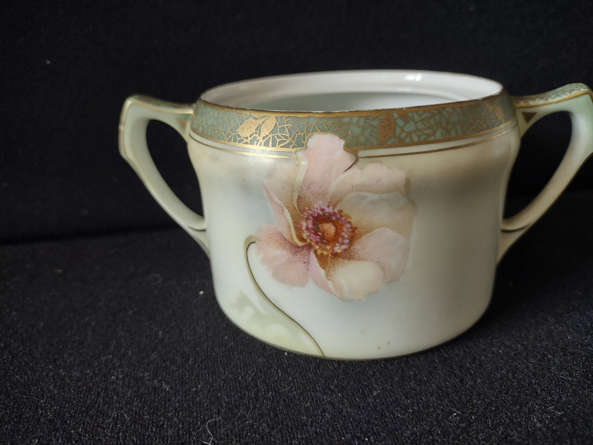 Sugar bowl side view showing blush pink open wild roses on pale cream-green ground