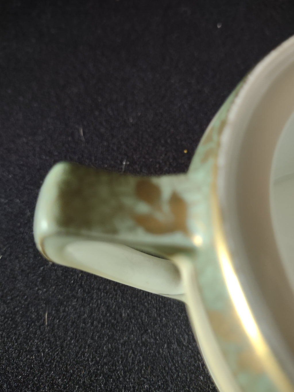 Sugar bowl handle close-up showing WEAR and gold loss on handle top consistent with age