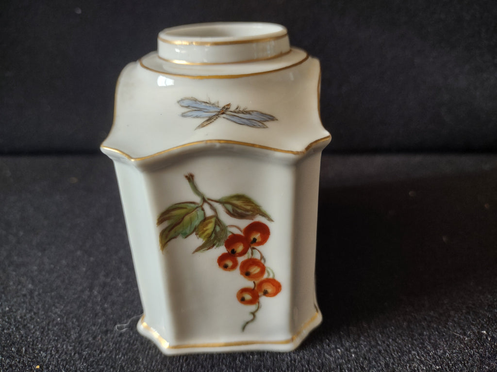 Tea caddy three-quarter view showing octagonal faceted form with scalloped shoulder edges