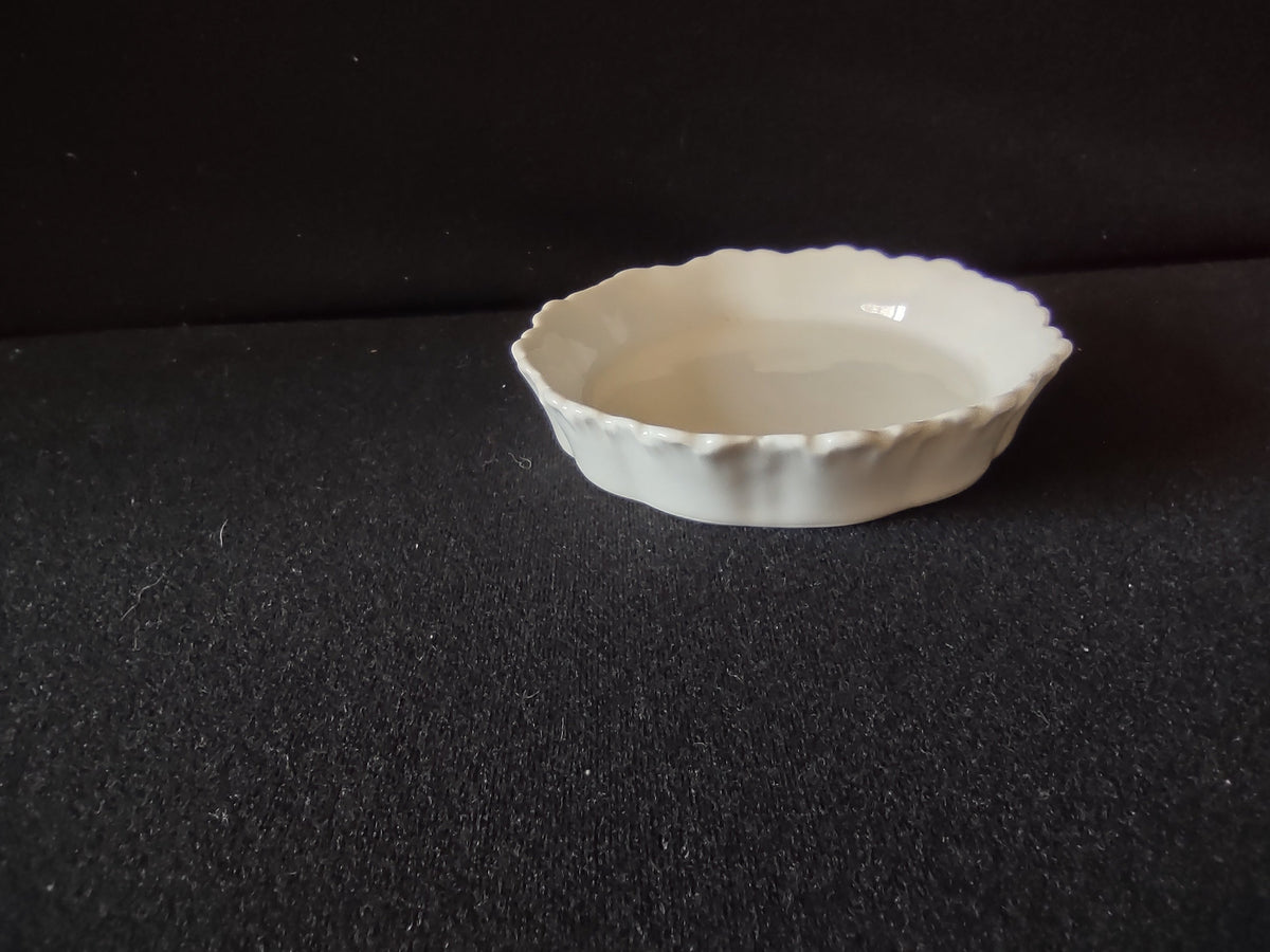 Vintage Meissen porcelain nappy dish top-down view showing brilliant white scalloped rim and bowl interior
