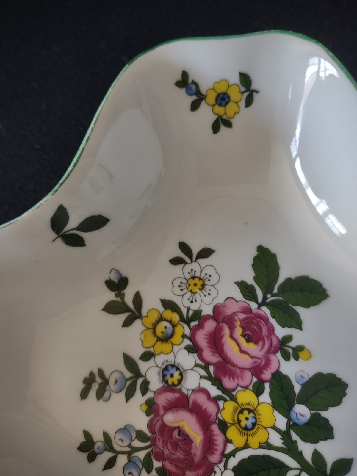 Royal Tettau candy dish rim edge close-up showing teal green rim line with wear and paint loss consistent with age