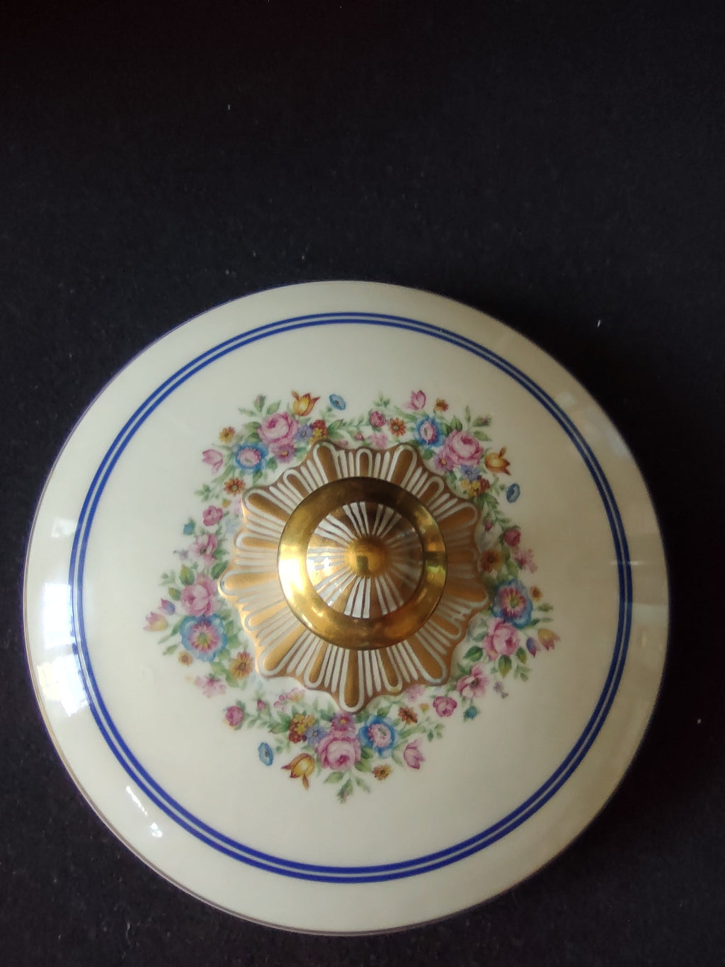 Limoges serving bowl angled view showing profile of domed lid with gold finial and bowl with gilt handles