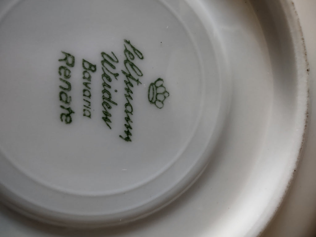 Vintage Schumann Bavaria porcelain cup top view showing brilliant mirror gold interior wash with white rim and scrolled gold handle