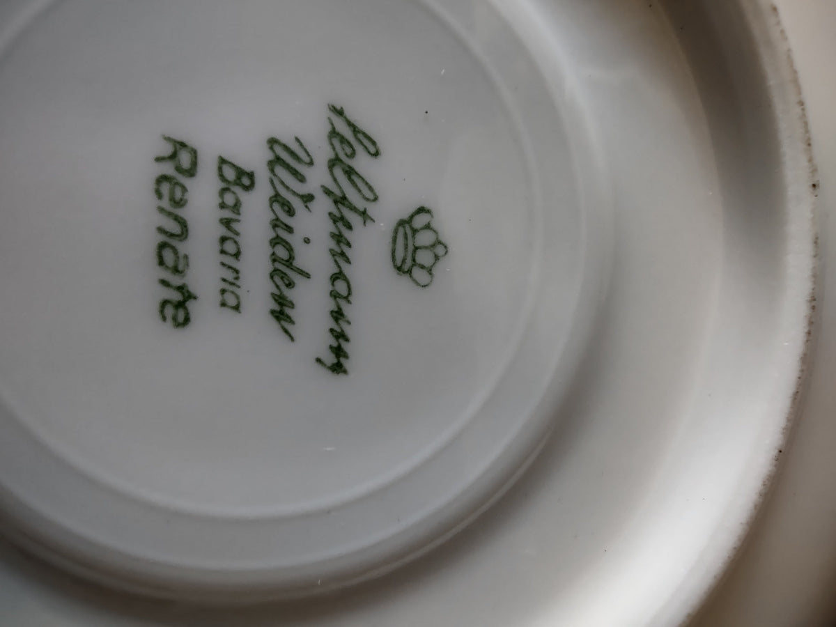 Vintage Schumann Bavaria porcelain cup top view showing brilliant mirror gold interior wash with white rim and scrolled gold handle