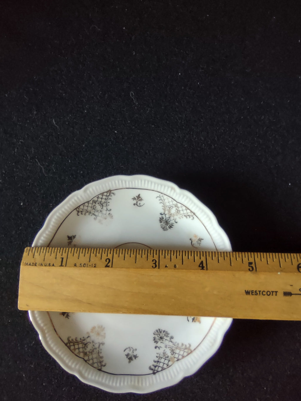 Seltmann Weiden Renate saucer with ruler showing approximately 5.5 inch diameter on dark background