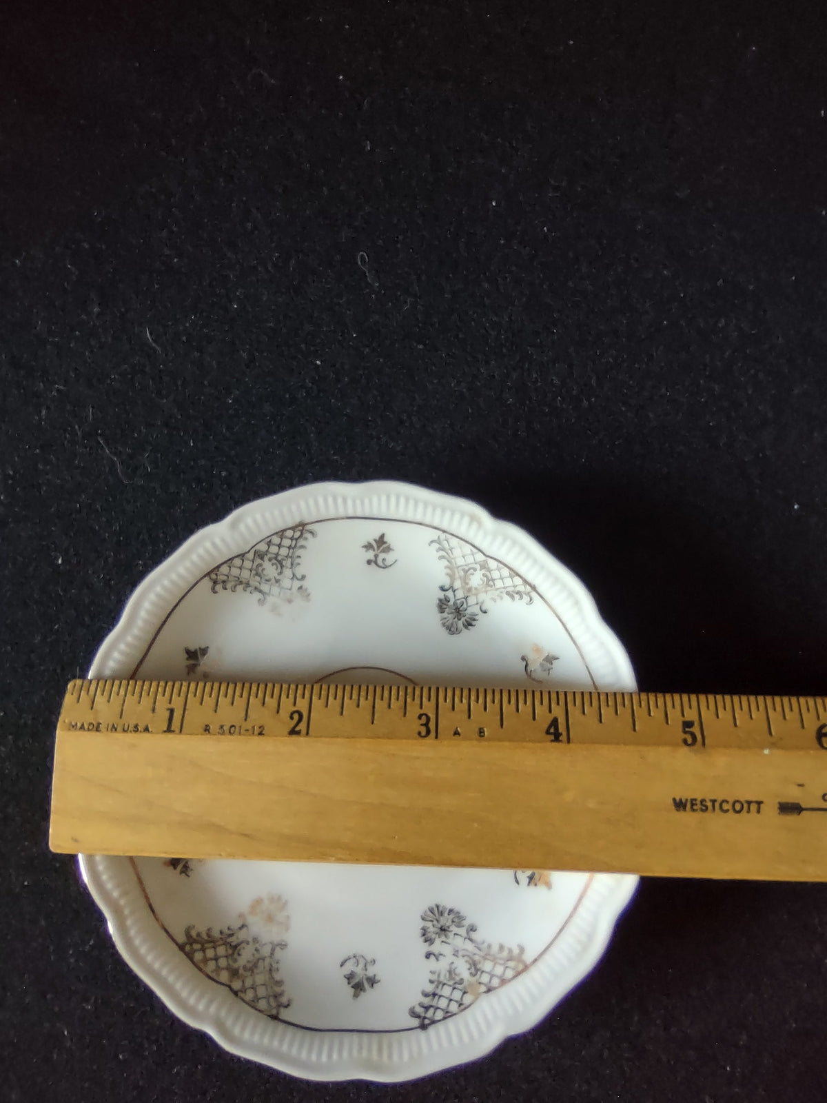 Seltmann Weiden Renate saucer with ruler showing approximately 5.5 inch diameter on dark background