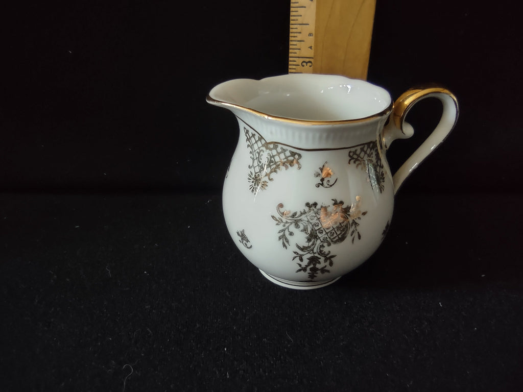 Seltmann Weiden Renate creamer handle side view showing scrolled gold handle detail and gold rim and foot lines