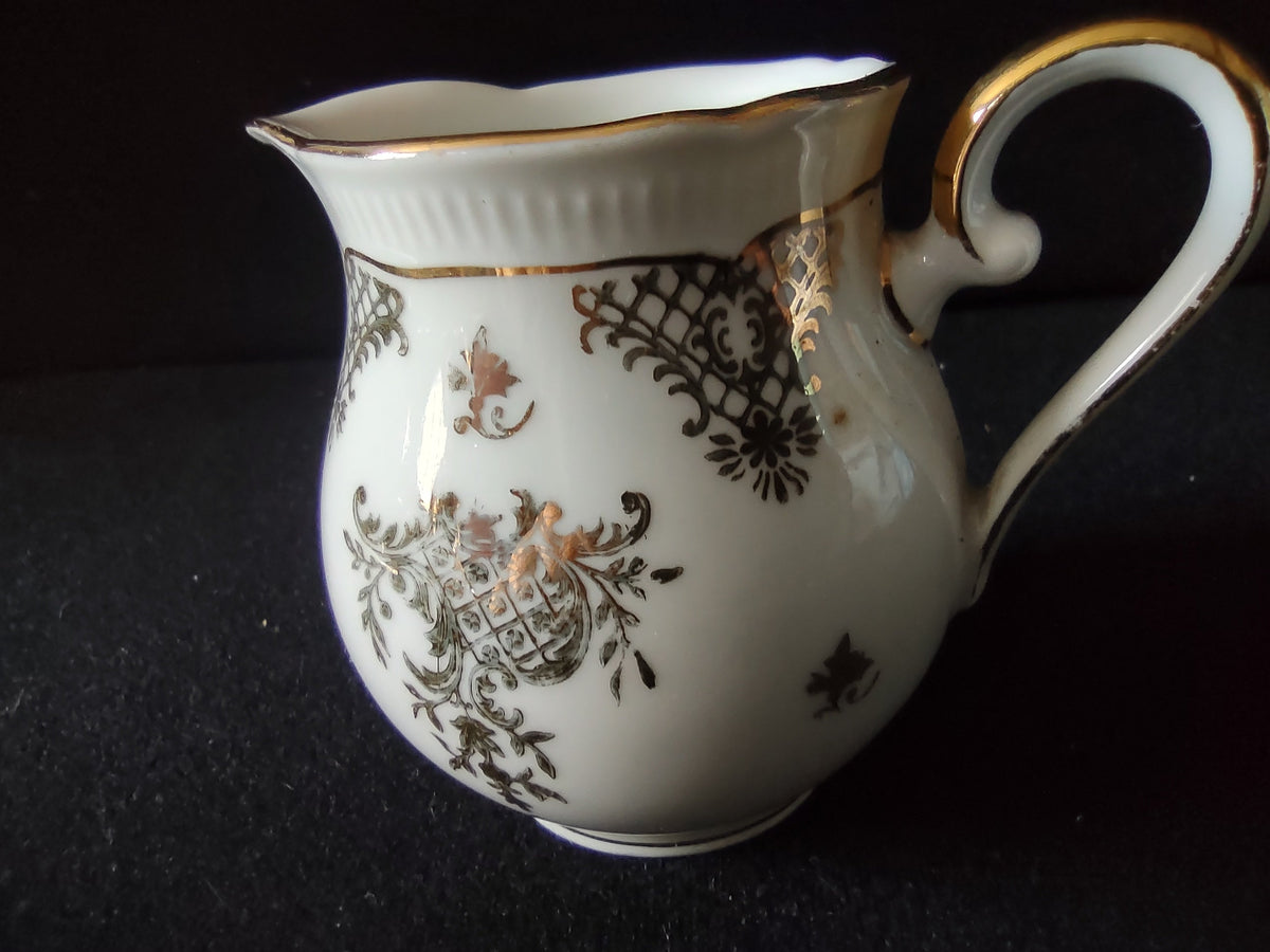 Seltmann Weiden Renate creamer three-quarter view showing overall form bulbous body scalloped spout and full Renate pattern