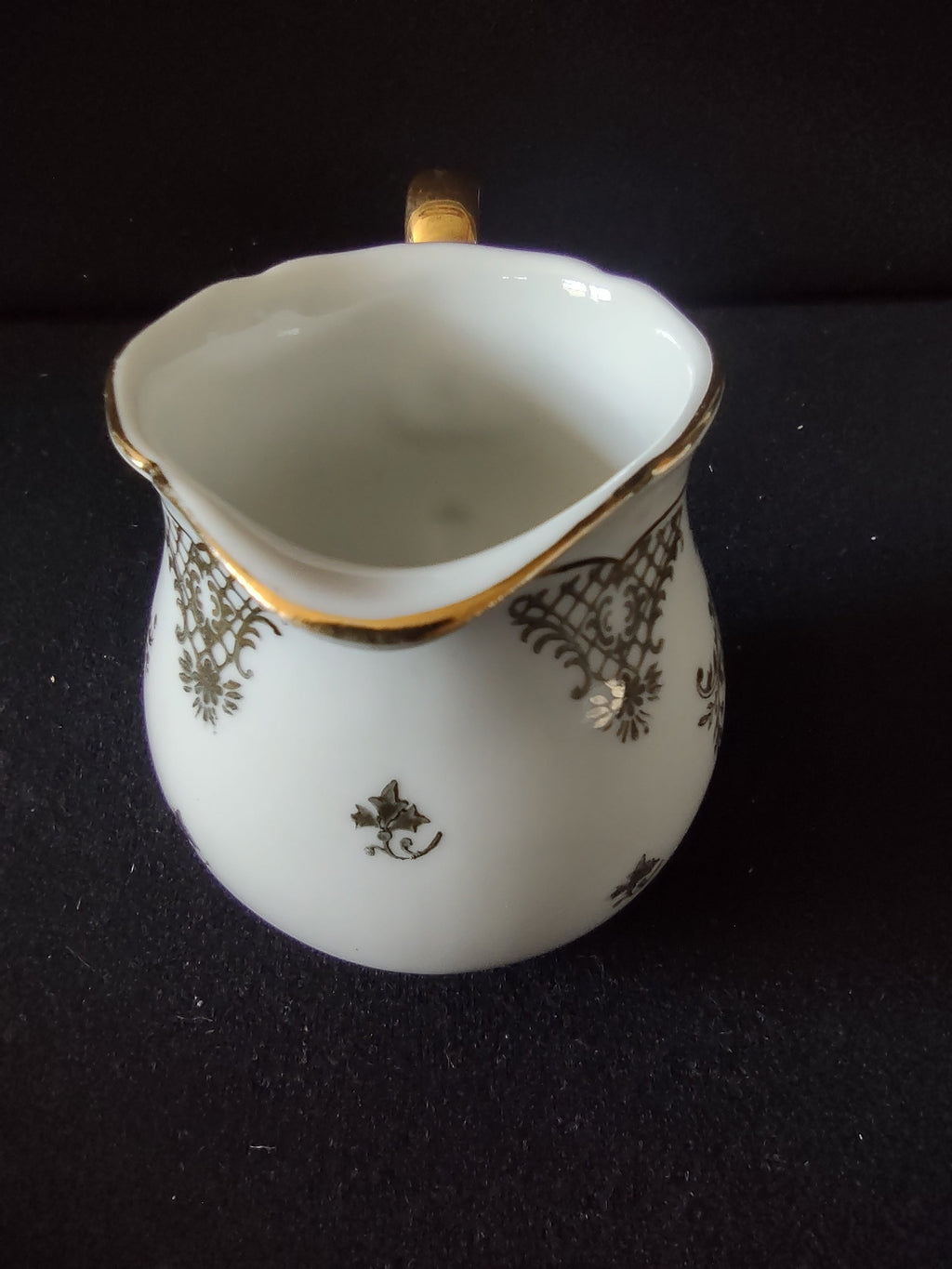 Seltmann Weiden Renate creamer angled view showing ribbed fluted upper neck and gold rim line detail