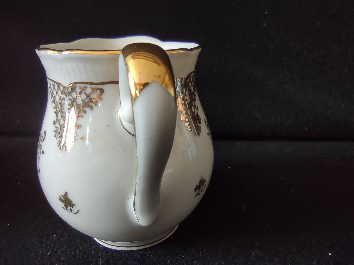 Seltmann Weiden Renate creamer full profile view showing complete form with handle spout and gold foot ring line