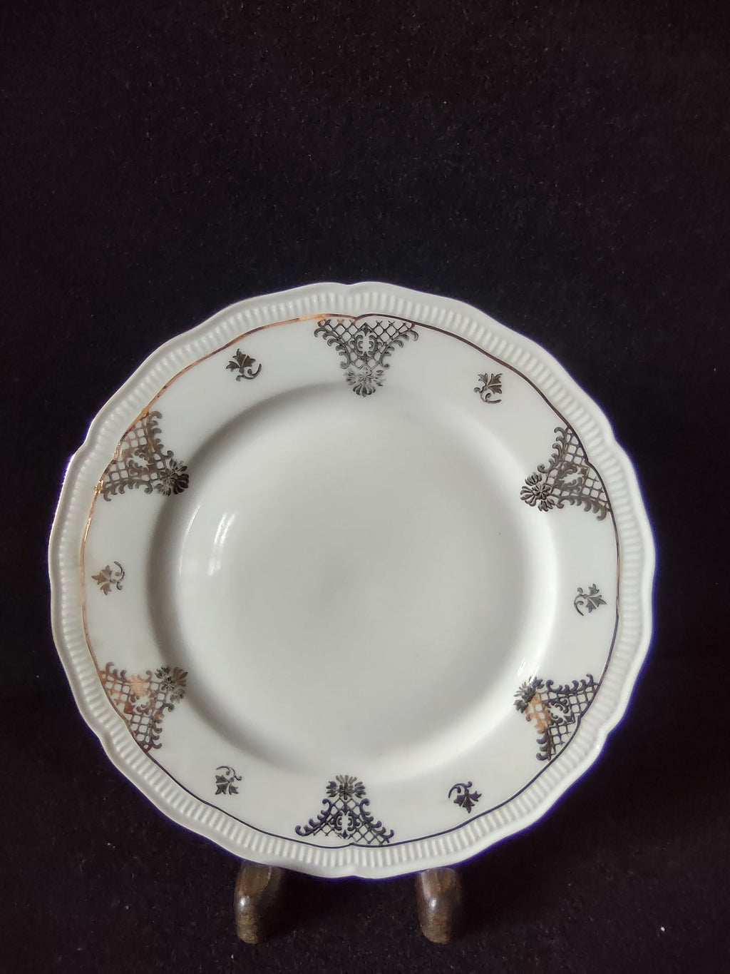 Vintage Seltmann Weiden Bavaria Renate pattern plate top view showing dark olive-gold trellis cartouches acanthus scrolls fleur-de-lis and scattered gold sprigs on embossed bead rim