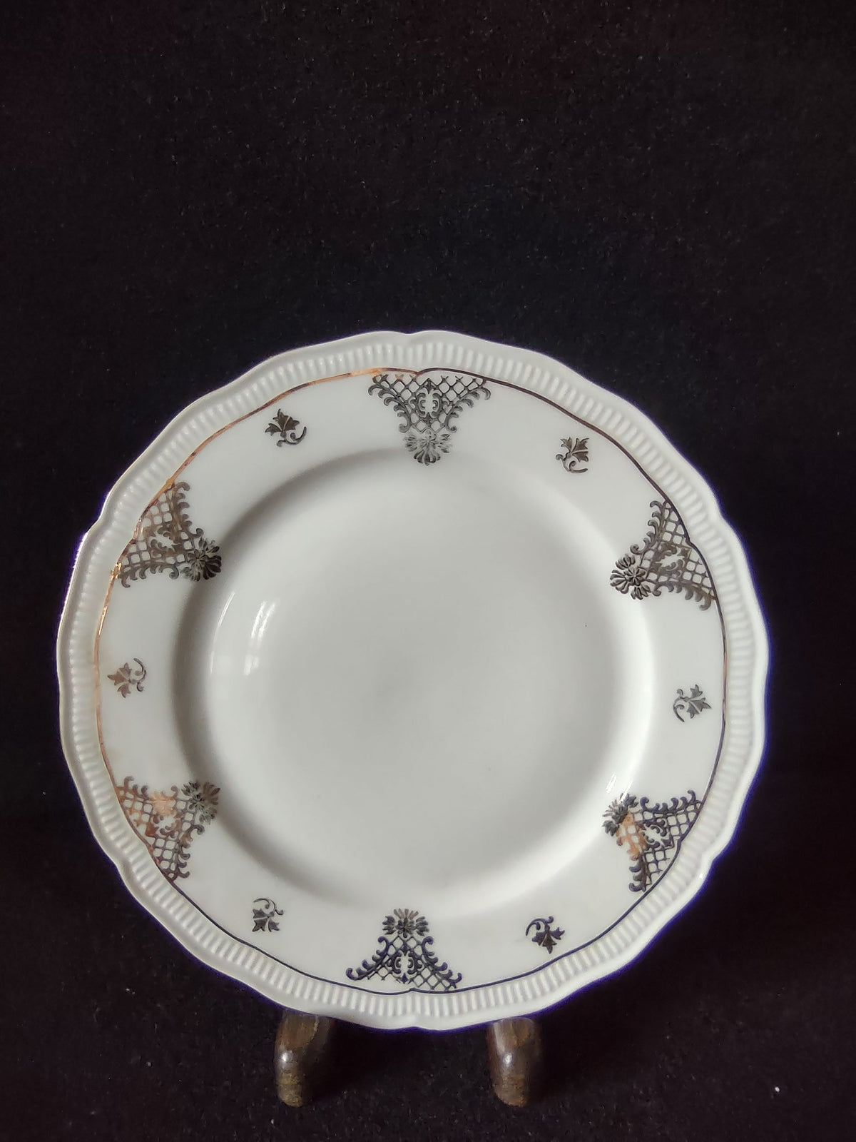 Vintage Seltmann Weiden Bavaria Renate pattern plate top view showing dark olive-gold trellis cartouches acanthus scrolls fleur-de-lis and scattered gold sprigs on embossed bead rim