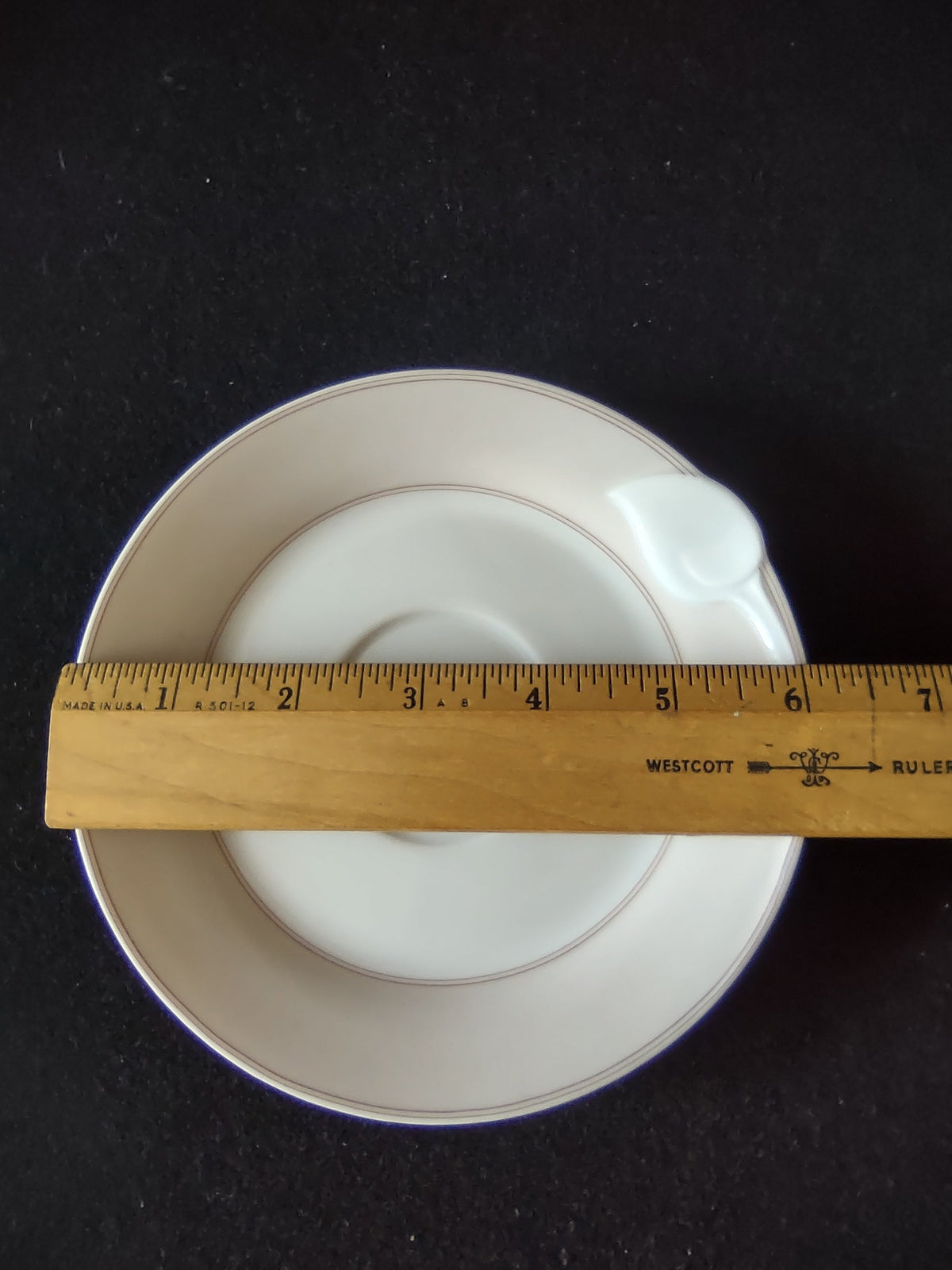 Hutschenreuther Chloe Huron Fontaine saucer with ruler showing approximately 6 inch diameter on dark background
