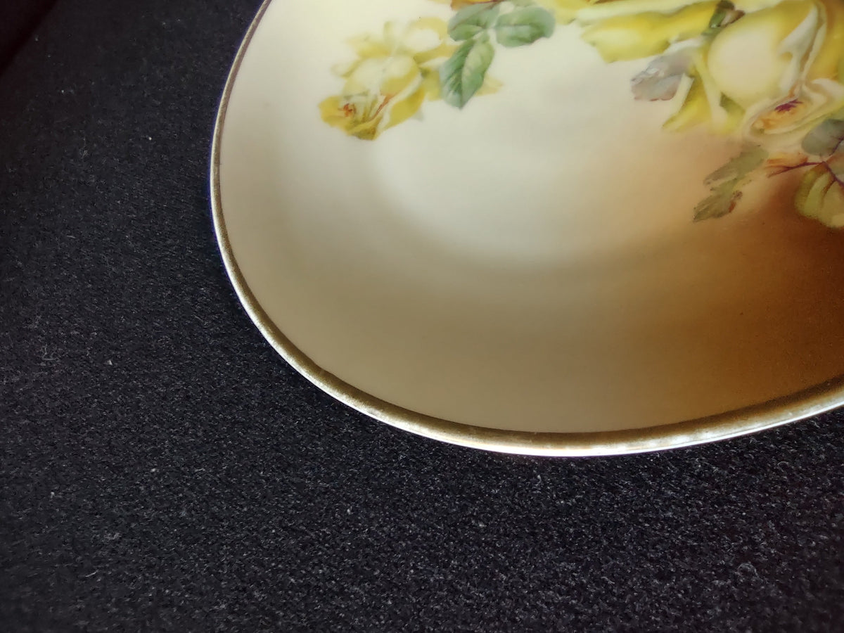 Hand-painted yellow roses plate second angled profile view showing rim thickness and smooth body form
